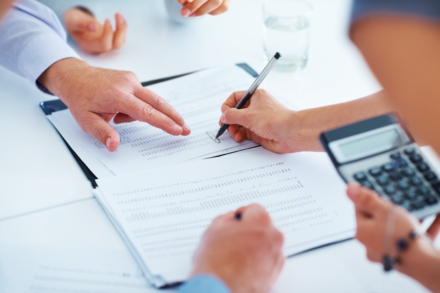 People reviewing financial documents during a transaction